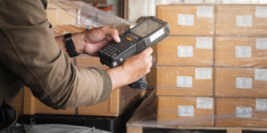 person using scanner in warehouse for barcode inventory system