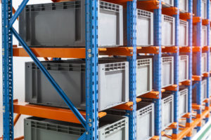 plastic boxes for the cells of the automated warehouse. Metal construction warehouse shelving